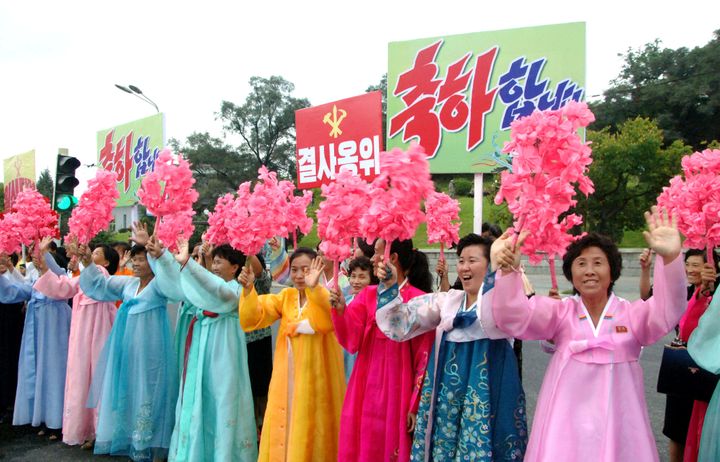 North Koreans cheer as members who worked on the test arrive in Pyongyang 