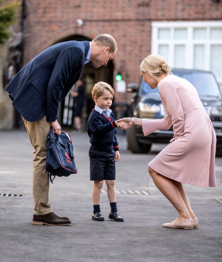 Helen Haslem, head of the lower school greeting Prince George and the Duke of Cambridge at Thomas's Battersea in London, as he starts his first day of school.