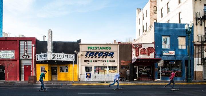 UNITED STATES - FEBRUARY 22: Skateboarders zip past a colorful row of small businesses in downtown El Paso, Texas (Photo by Carol M. Highsmith/Buyenlarge/Getty Images)