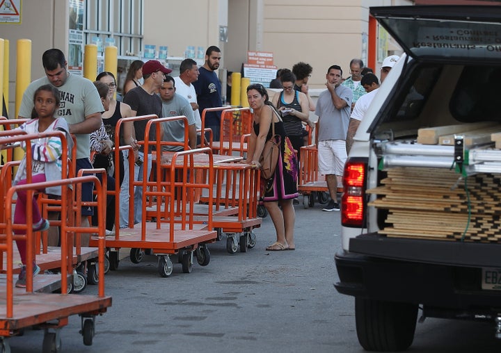 People wait in line to purchase plywood at Home Depot in Miami as they prepare for Hurricane Irma on Sept. 6, 2017.