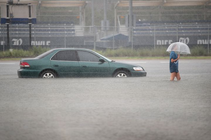A woman walks through a flooded parking lot at Rice University in Houston last week. 