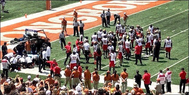 Medical and support personnel gather around Maryland cornerback Antwaine Richardson (left) as teammates wait for a sign that he’s OK.