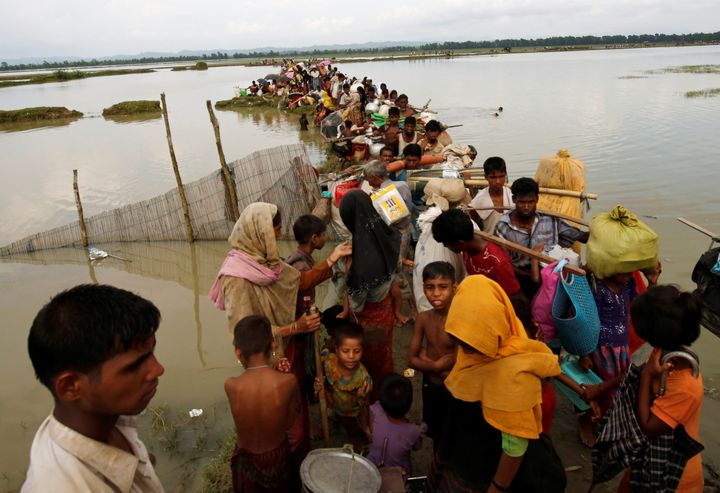 Rohingya refugees wait for a boat to cross a canal after crossing the border through the Naf river in Teknaf, Bangladesh on Thursday.