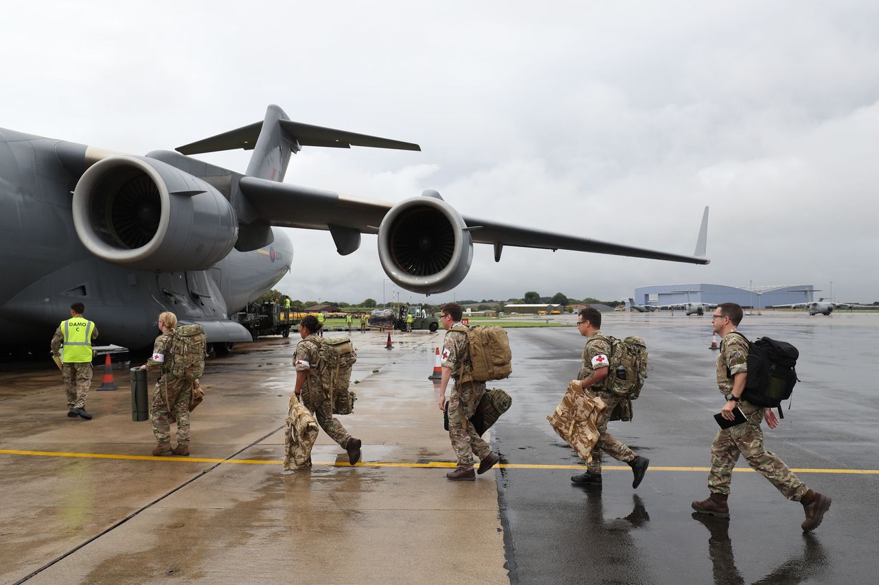 Soldiers board a Royal Air Force C-17 Globemaster III aircraft at Brize Norton before they are flown out to help those affected by Hurricane Irma 