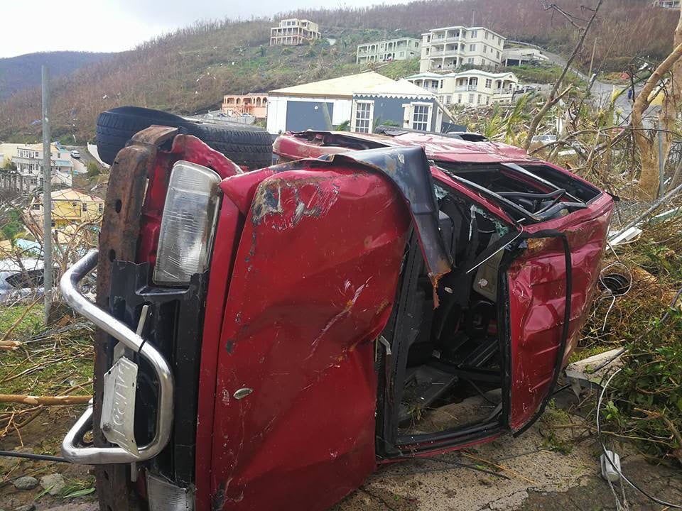 A truck lies on its side, having been battered in the storm