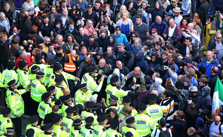 Police have arrested a fifth man in relation to an alleged National Action terror plot; officers are pictured above trying to protect members of the group from counter-protesters during a march in Liverpool in 2015