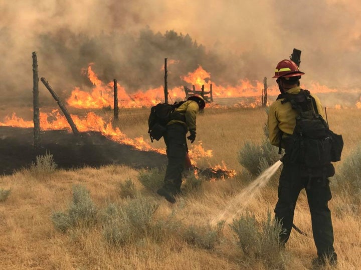 Wildland firefighters battle the Bridge Coulee Fire north of Mosby, Montana, on July 21, 2017.