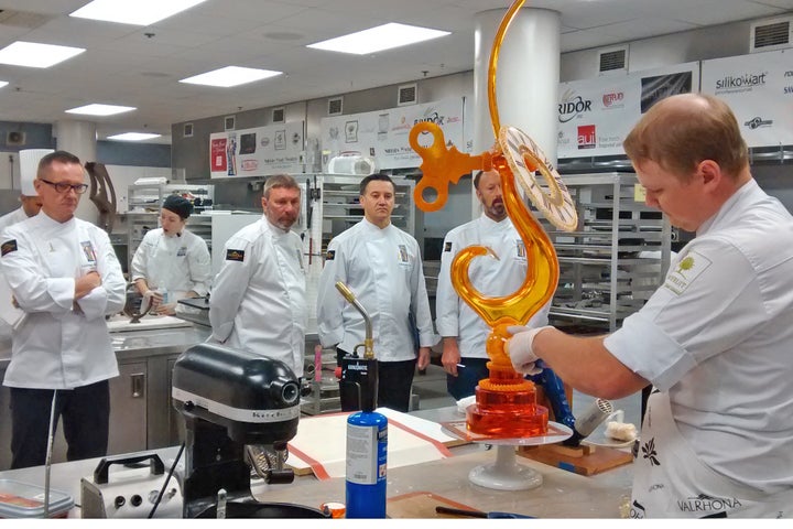 All eyes on Jordan Snider, who keeps cool as Team USA coach Laurent Branlard (left) looks on with fellow judges Roy Pell, Christophe Feyt and Derek Poirier 