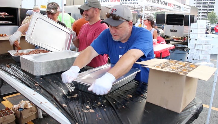 Packaging up 1000’s of hot meals in the volunteer assembly lines at Operation BBQ Relief 