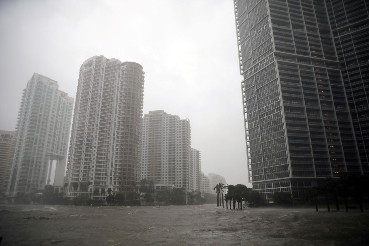 Water rises up to a sidewalk by the Miami river as Hurricane Irma arrives in south Florida.