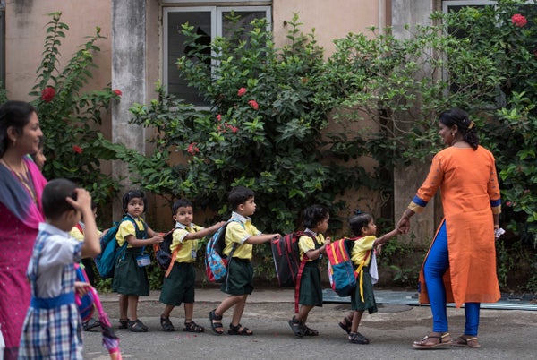 Children enjoy the first day of school at Mahila Sangh School, Vile Parle in Mumbai, India.