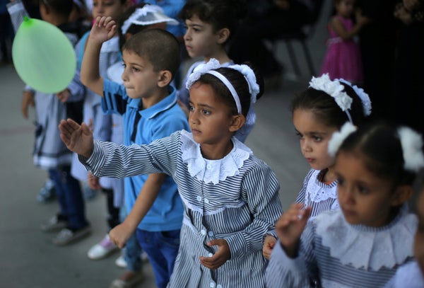 Palestinian schoolchildren play on the first day of a new school year, at a United Nations-run school in Deir al-Balah refuge