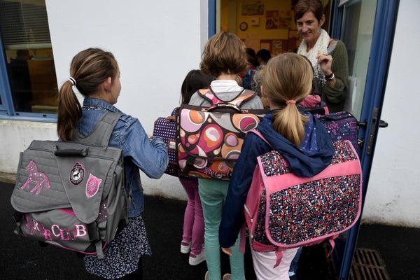 Pupils enter their classroom in a primary school on the first day of the new school year on Sept. 4, 2017, in Quimper, wester