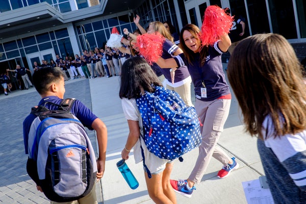Teacher Margaret Upp and the rest of the teaching staff greet students on the first day of classes at the newly opened Brambl