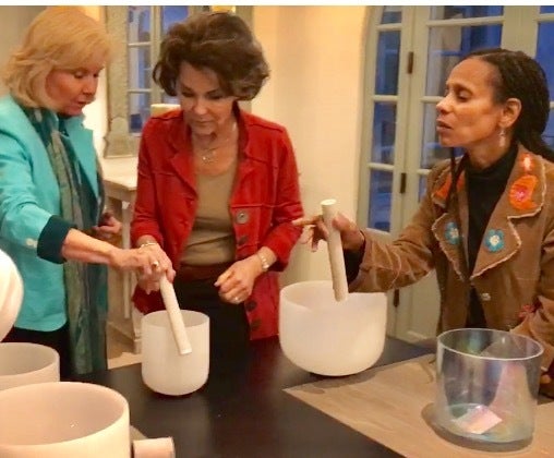 <p>Flicka teaching crystal singing bowls during sound healing workshop</p>