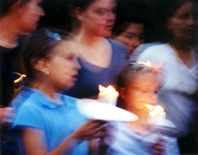 Two nights after the Twin Towers fell, in Union Square Park, New Yorkers singing God Bless America. 