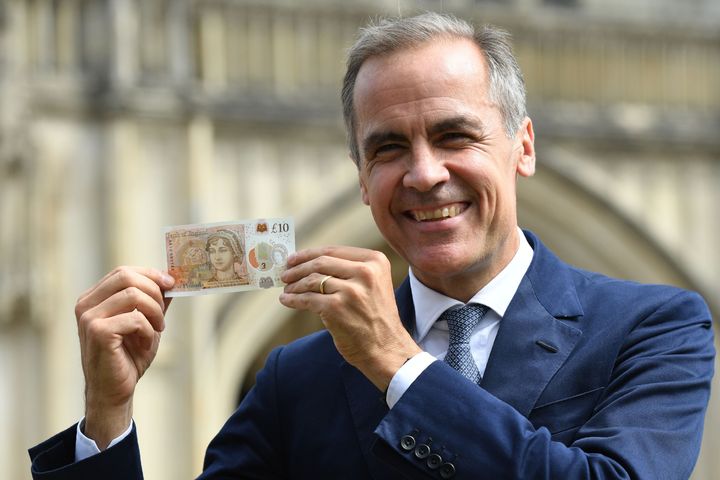 Bank of England governor Mark Carney poses with the new note