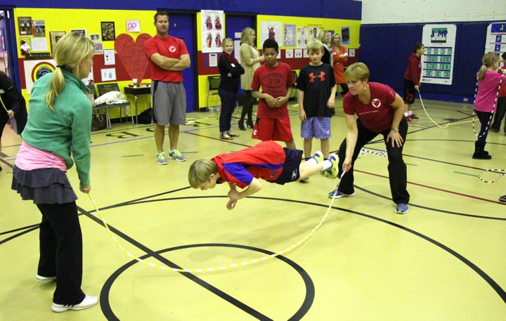 <p>Kris turns one end of the rope as a student performs a trick move.</p>