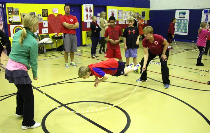 Kris turns one end of the rope as a student performs a trick move.