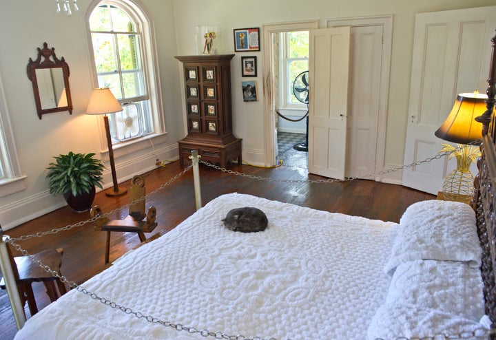 A cat sleeps on a bed on Feb. 18, 2013, at the Key West home where author Ernest Hemingway lived and wrote for a decade.