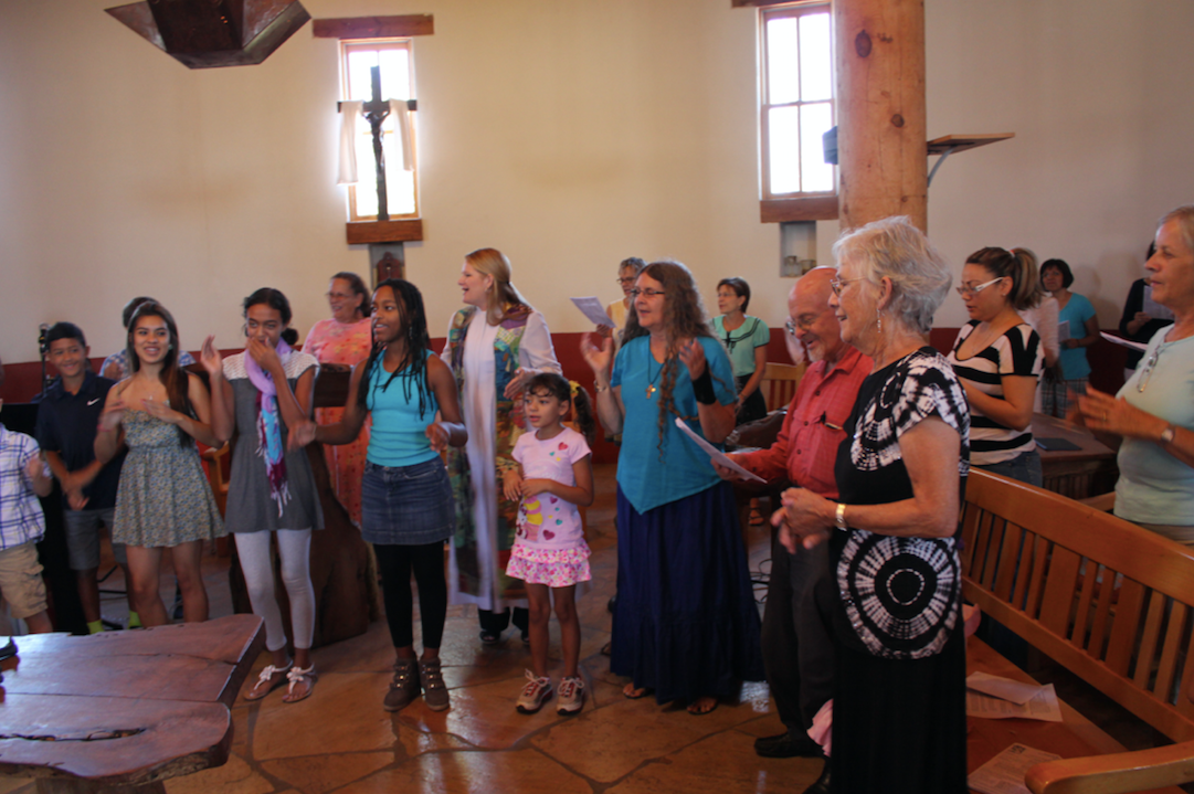 Rev. Alison Harrington (center, in white robe) leading her congregation in worship at Southside Presbyterian Church in Tucson, Arizona, in 2013.