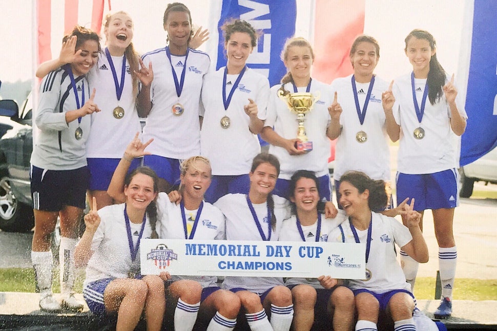 Karla Perez, left, with her soccer club in 2010. As a high school junior, she turned down a full-ride soccer scholarship because she didn't want to tell the coach she couldn't travel due to her status. 