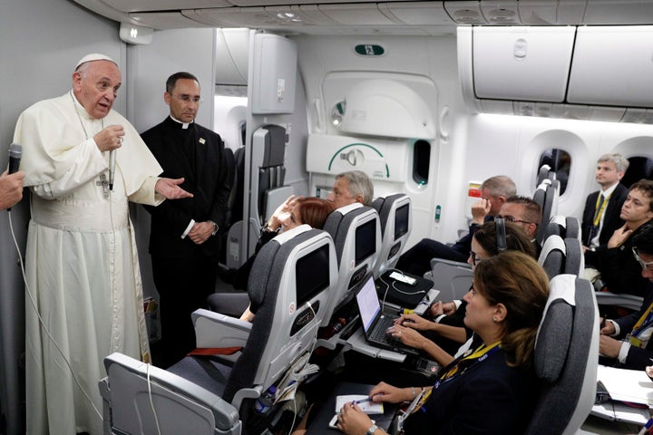 Pope Francis talks to journalists during a press conference aboard a plane to Rome at the end of his visit to Colombia