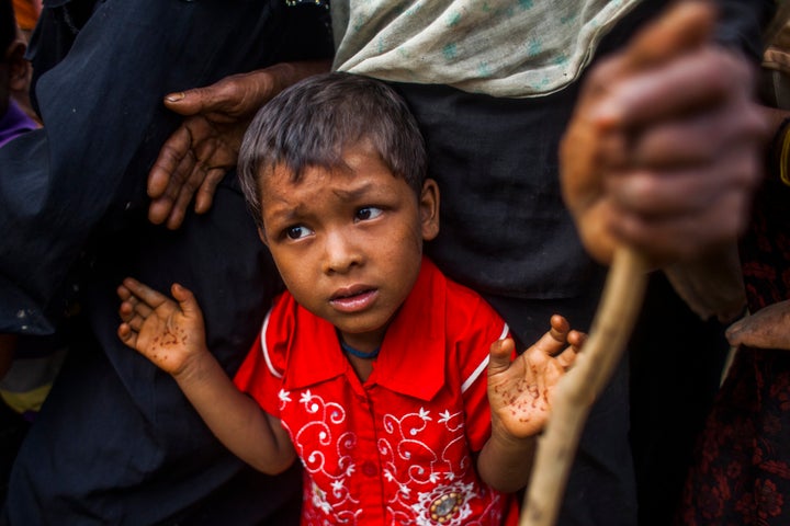 Rohingya Muslim refugees wait for medical support near a camp at a temporary makeshift shelters after crossing over from Myan