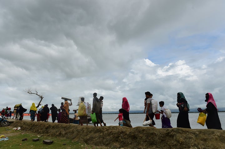 Rohingya Muslim refugees arrive from Myanmar after crossing the Naf river in the Bangladeshi town of Teknaf on September 12,