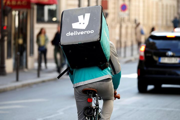 A cyclist rides a bicycle as he delivers food for Deliveroo, an example of the emergence of what is known as the 'gig economy