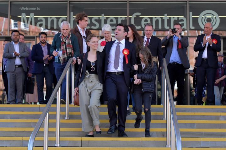 Labour's Andy Burnham (C) celebrates winning the Greater Manchester mayoral election with wife Marie-France van Heel (L) and daughter Annie (R) at Manchester Central