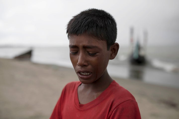 A young Rohinga boy cries after the wooden boat he was traveling on from Myanmar crashed into the shore, Sept. 12, 2017, in D