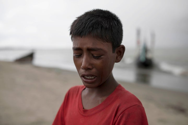 A young Rohinga boy cries after the wooden boat he was traveling on from Myanmar crashed into the shore, Sept. 12, 2017, in Dakhinpara, Bangladesh.