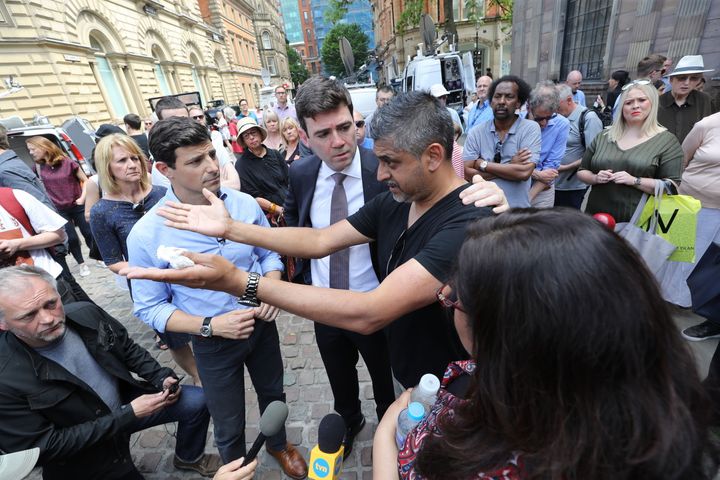 Burnham comforts Hashim Norat as he is interviewed in St Ann's Square, Manchester, where a minute's silence was held to remember the victims of the terror attack