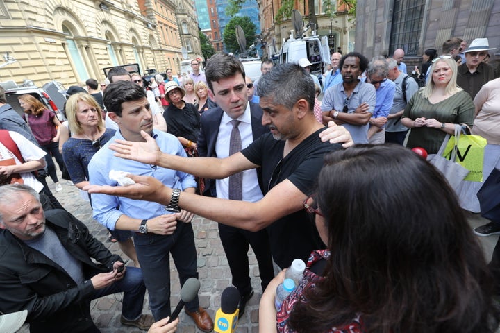 Burnham comforts Hashim Norat as he is interviewed in St Ann's Square, Manchester, where a minute's silence was held to remember the victims of the terror attack