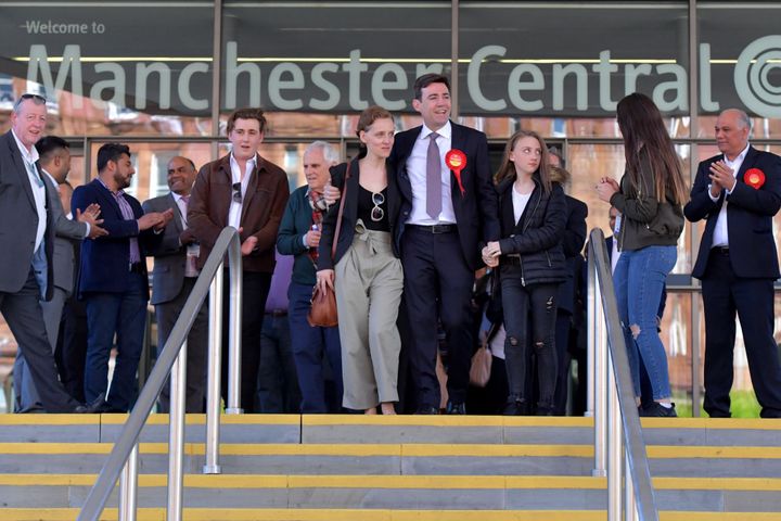 abour's Andy Burnham (C) celebrates winning the Greater Manchester mayoral election with wife Marie-France van Heel (L) and daughters Annie (third right) and Rosie (second right) at Manchester Central on May 5, 2017 in Manchester, England. Six new metro Mayors are being elected in areas including Greater Manchester, West Midlands and the West of England
