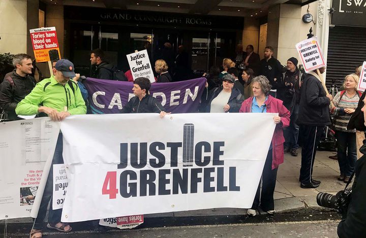 Protesters outside the Grenfell Tower public inquiry demonstrate before it began