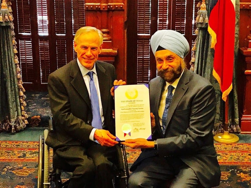 Texas Governor Greg Abbott (left) received papers of the shipment from Indian Ambassador to the United States Navtej Sarna (