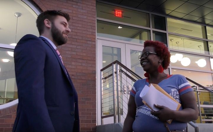 Angelia Bradley and her lawyer, Nathaniel Carroll, stand outside Ferguson's Municipal Court building. Bradley performed community service in lieu of fines she faced for various traffic tickets.