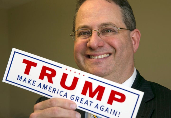 <p>Trey Trainor poses with a Trump campaign sticker at the Akerman Law Firm in Austin, Texas. </p>