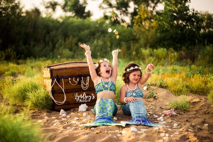 The girls' mom bought mermaid tails for the shoot. 