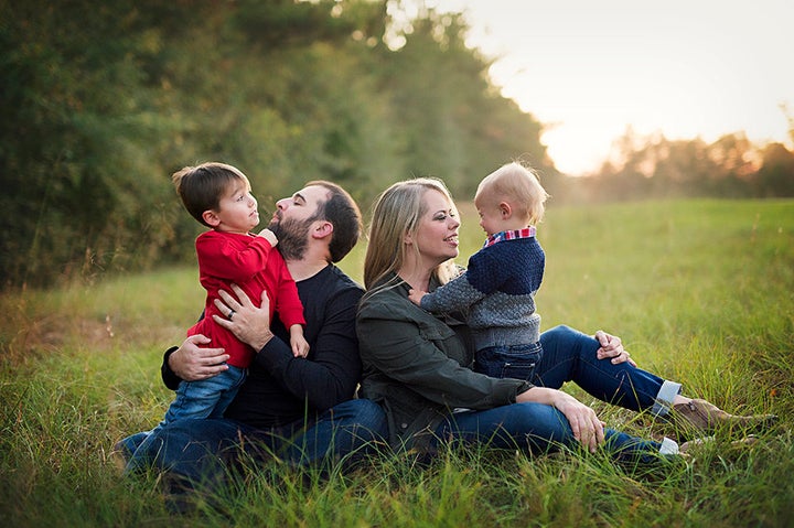 Stephanie Hicks poses with her husband and two sons. She was driven off the police force after the birth of her older boy.