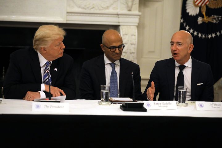 Washington Post owner Jeff Bezos, right, speaks during a meeting with President Donald Trump on June 19, 2017, alongside Microsoft CEO Satya Nadella, center.
