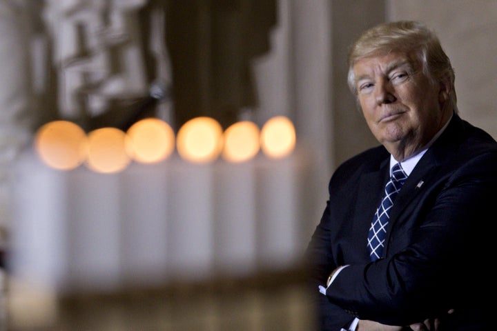 U.S. President Donald Trump sits near memorial candles after being lit at the Remembrance ceremony, hosted by the U.S. Holocaust Museum, in the U.S. Capitol Rotunda in Washington, D.C., U.S., on Tuesday, April 25, 2017.