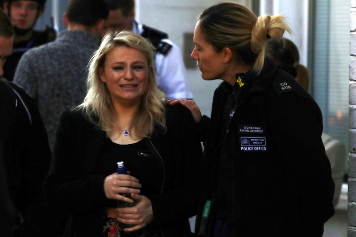 A woman is comforted by police following the rush hour attack in west London