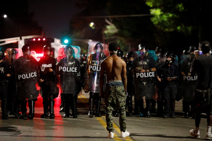 A protester faces off with law enforcement officials after Jason Stockley, a former St. Louis police officer, was acquitted o