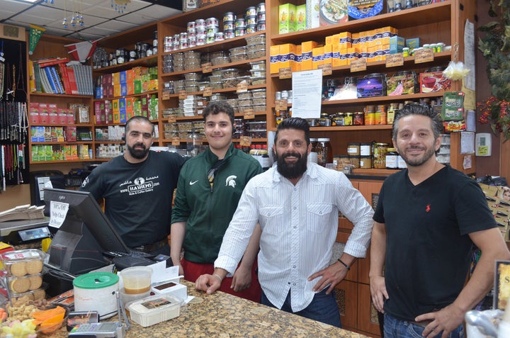 <p>From right to left, Wessam Hashem, Adam Hashem and several of the workers at Hashem’s Nuts & Coffee Gallery offering high-end, organic sweets, coffee and teas in Dearborn, Mich.</p>