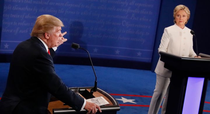 Then-Republican presidential nominee Donald Trump speaks as then-Democratic presidential nominee Hillary Clinton looks on during the final presidential debate on Oct. 19, 2016. 