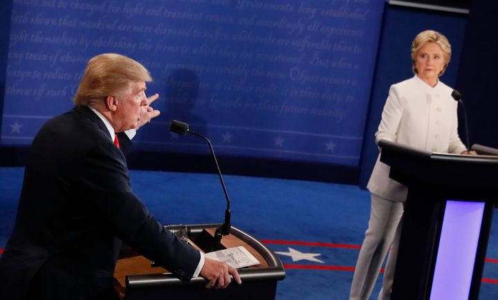 Then-Republican presidential nominee Donald Trump speaks as then-Democratic presidential nominee Hillary Clinton looks on during the final presidential debate on Oct. 19, 2016. 