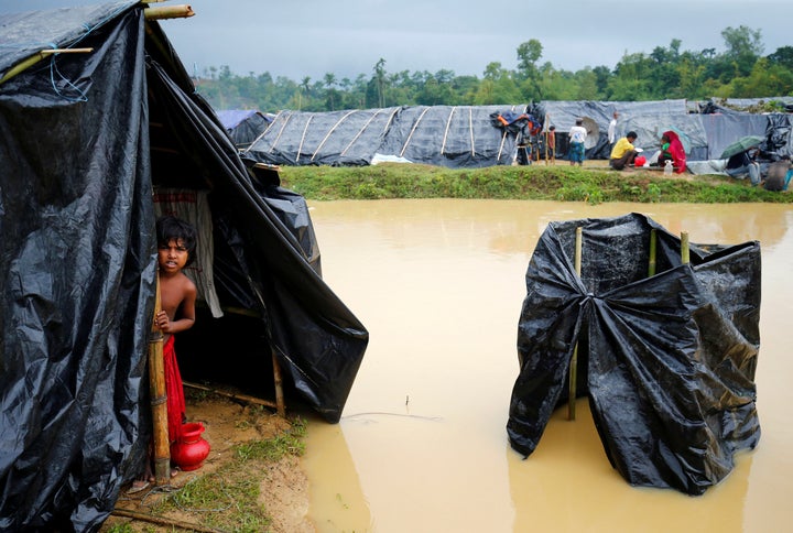 A Rohingya refugee girl looks out as makeshift shelters become flooded due to heavy rain in Cox's Bazar, Bangladesh, Septembe